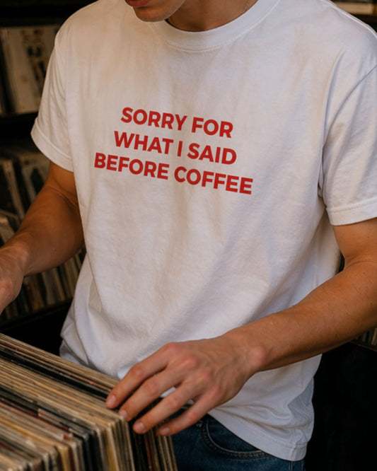Sorry For What I Said Before Coffee organic graphic T-shirt with funny coffee quote printed on front in minimalist design