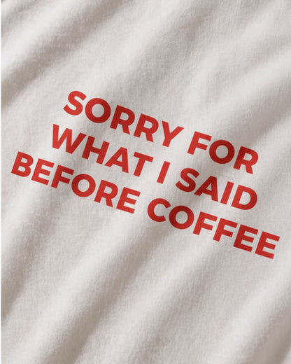 Sorry For What I Said Before Coffee organic graphic T-shirt with funny coffee quote printed on front in minimalist design